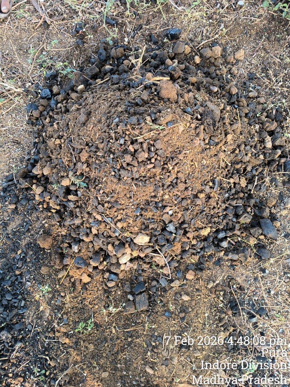 Biochar material being mixed with soil and organic matter